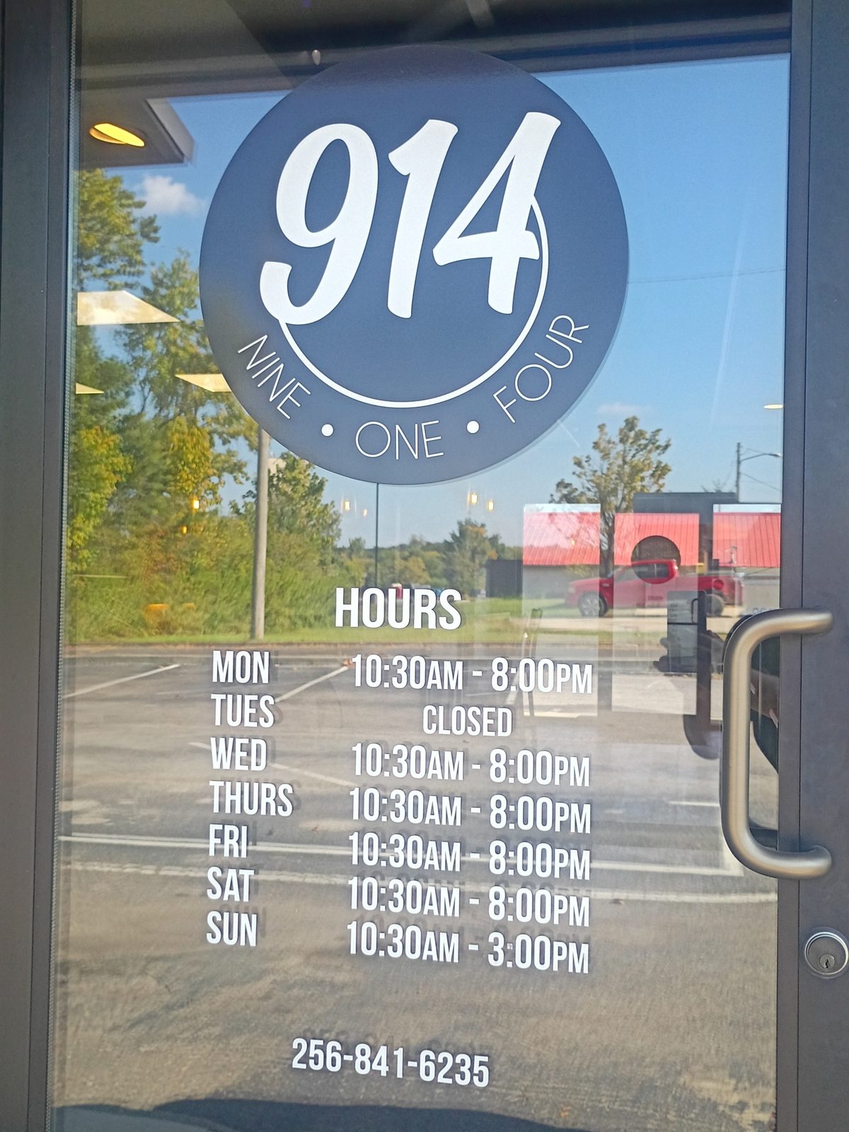 The Nine One Four front door with the 914 logo and opening hours